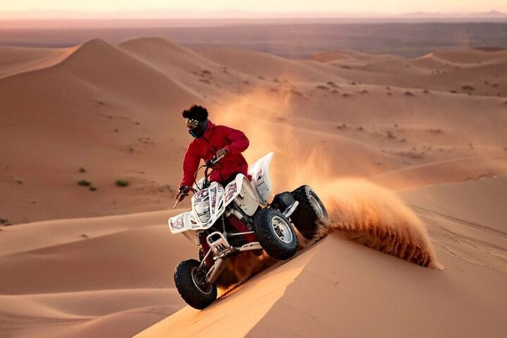 Experience the thrill of gliding through expansive red dunes on a quad bike paired with a serene camel ride that connects you to the rich culture of the desert landscape.